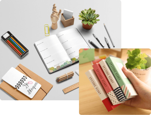 Office desk with notebook, plant, and stationery